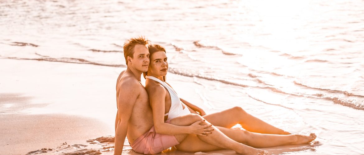 couple lying on beach looking at sunset to increase low sexual desire