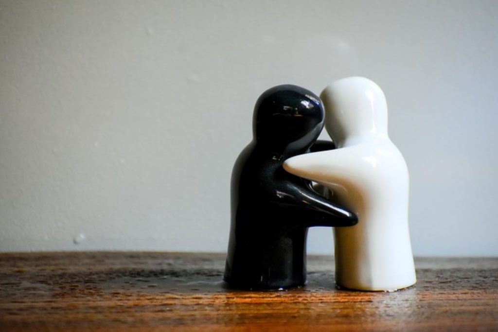 black and white statues hugging sharing emotional intimacy