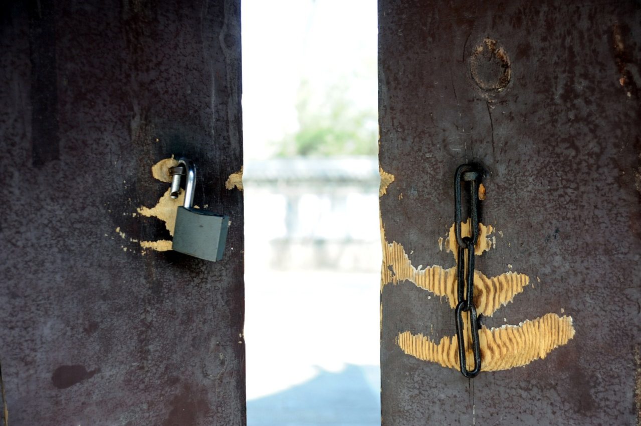 looking through an open door with a broken lock.